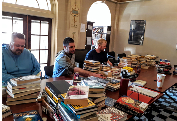 Parolees process books for their library