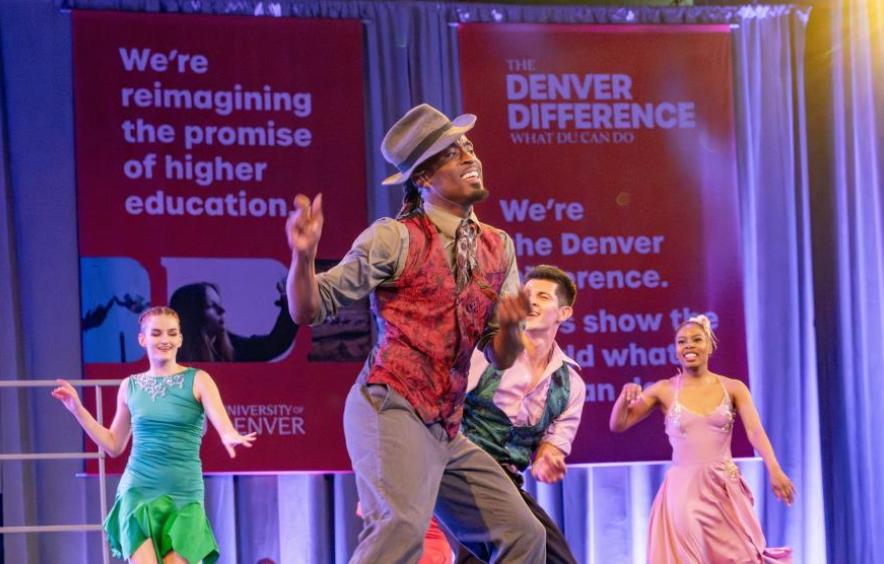 Performer dancing on stage and smiling