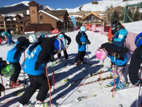 Zavila, at right in the black helmet, leads athletes in an imagery exercise before beginning a run.