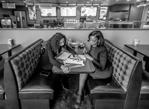 Lisa Calderón and Candi CdeBaca looking over documents